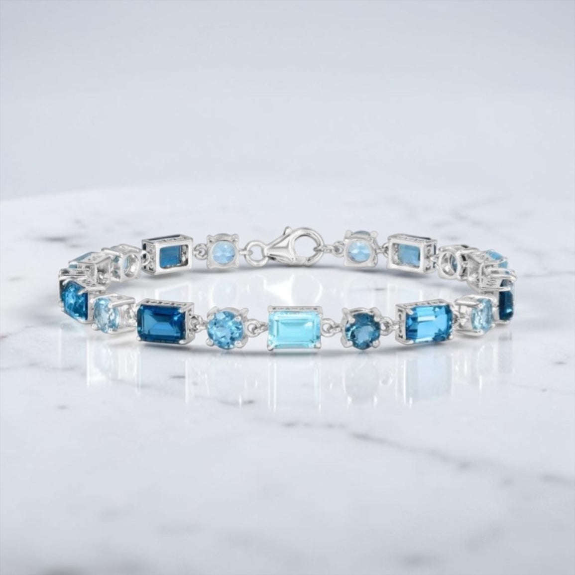 Sterling Silver Round & Emerald-Cut 17.05cttw Gem Bracelet - Swiss, London, & Sky Blue Topaz